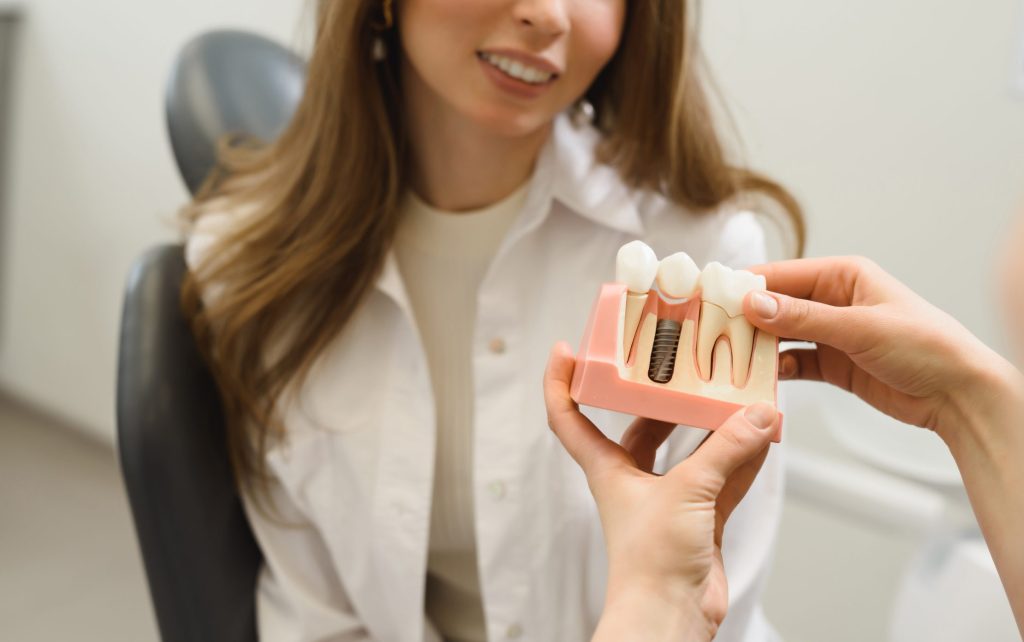 woman looking at dental implant display