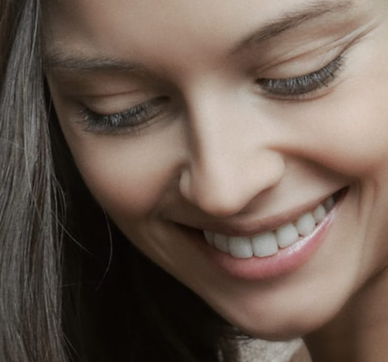 Women smiling happy about getting a fluoride treatment